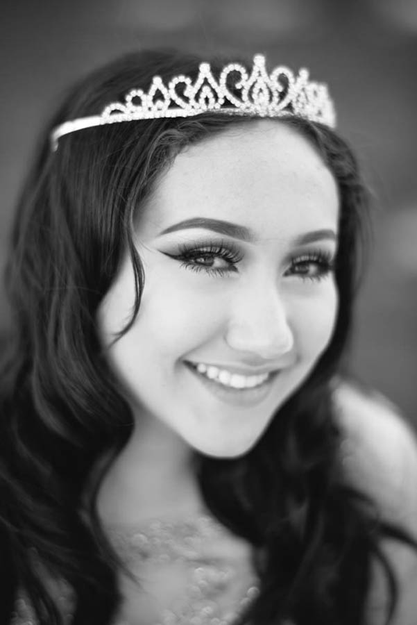 La Quinceañera smiles anxiously waiting for her day to start in Sacramento, CA