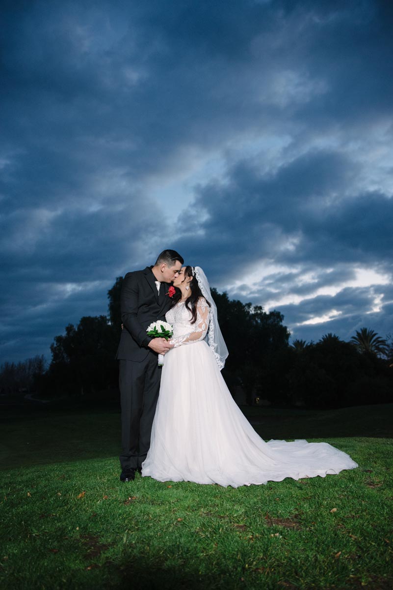 The bride and groom looking lovingly at each other before the rain comes in Brentwood CA