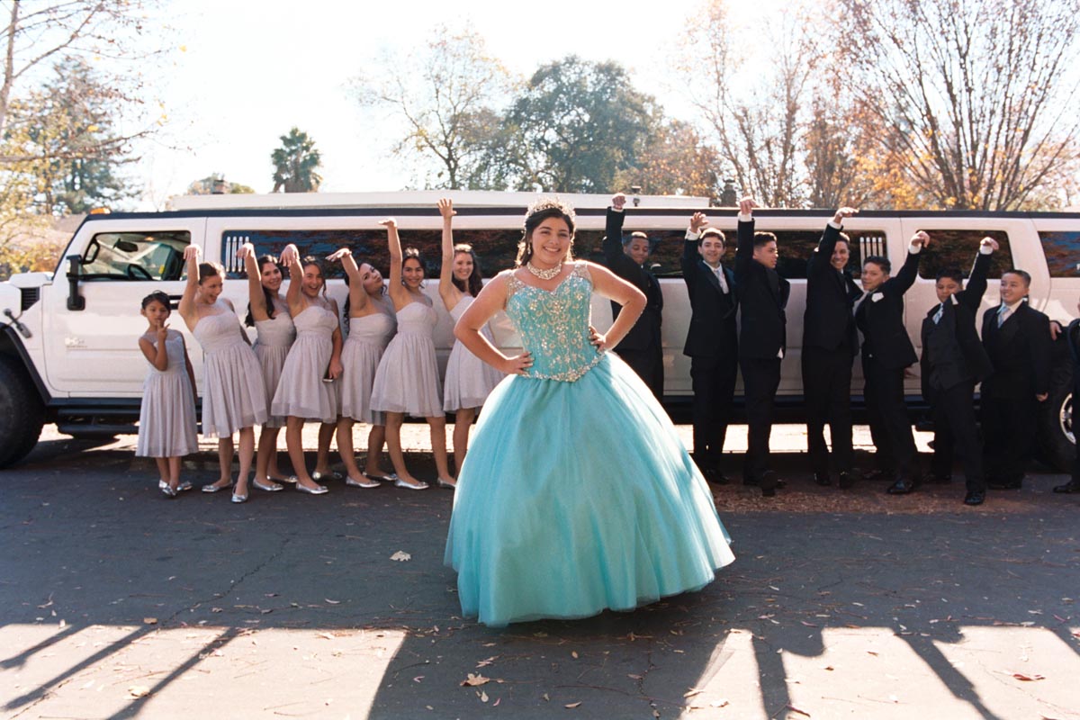 La Quinceañera with her court in front of the limo in Davis, CA